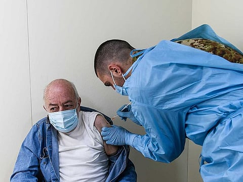 A health worker of the Italian Army administers a dose of the AstraZeneca vaccine for COVID-19 to a patient at a vaccination centre set up at the Allianz Stadium in Turin, northern Italy, Wednesday, March 24, 2021.