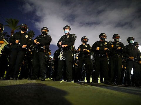 Police officers look on during an eviction of the homeless encampments at Echo Park Lake, amid the outbreak of the coronavirus disease (COVID-19), in Los Angeles, California, U.S.