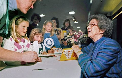 In this April 19, 1998 file photo, Beverly Cleary signs books at the Monterey Bay Book Festival in Monterey, Calif. The beloved children’s author, whose characters Ramona Quimby and Henry Huggins enthralled generations of youngsters, has died. She was 104. Cleary’s publisher, HarperCollins, announced her death Friday, March 26, 2021. In a statement, the company said Cleary died in Carmel, California, her home since the 1960s, on Thursday. No cause of death was given.