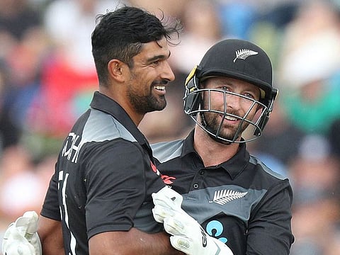 New Zealand's Ish Sodhi (L) is congratulated by wicketkeeper Devon Conway against Bangladesh