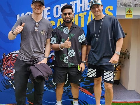Rishabh Pant, flanked by England players Sam Billings (left) and Tom Curran after reporting at their team hotel in Mumbai on Monday.
