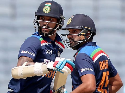 India's Shikhar Dhawan (left) and Rohit Sharma in action during their 17th century partnership, in the third One Day International against England at Maharashtra Cricket Association Stadium in Pune, India, on March 28, 2021.