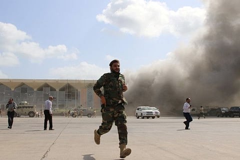A security personnel and people react during an attack on Aden airport moments after a plane landed carrying a newly formed cabinet for government-held parts of Yemen, in Aden, Yemen December 30, 2020.