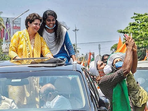 A Congress supporter clicks a selfie with party leader Priyanka Gandhi Vadra during her election campaigning at Karunagappally in Kollam district, Kerala. Not one to disappoint, Priyanka Gandhi was seen taking her SUV ride greeting people enthusiastically as they waved to her from everywhere roof-tops and buildings as her cavalcade passed.