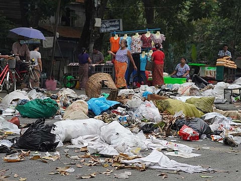 Residents use trash to block streets as a form of protest in Thaketa township, Yangon, Myanmar, on March 30, 2021.