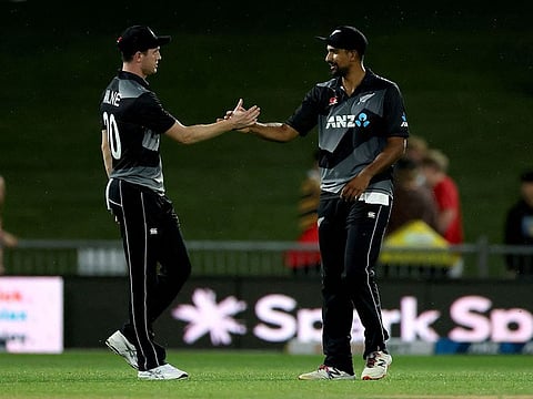 New Zealand's Ish Sodhi celebrates the team's victory over Bangladesh with teammate Adam Milne