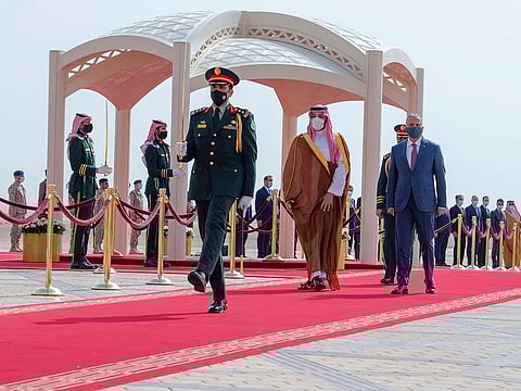 In this photo released by Saudi Royal Palace, Saudi Crown Prince Mohammed bin Salman, second right, accompanies Iraqi Prime Minister Mustafa Al Kadhimi upon his arrival at Riyadh international airport, Saudi Arabia, March 31, 2021.