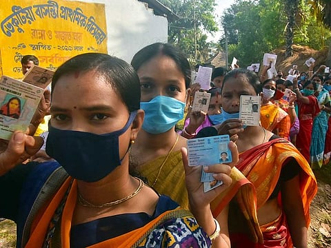 Voters show their voter-ID cards as they arrive to cast their vote during the second phase of West Bengal Assembly election at Nandigram, in East Midnapore on Thursday, April 1, 2021.