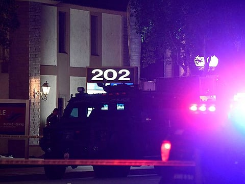 A police officer stands outside a building were multiple people were killed in a shooting in Orange, California on March 31, 2021.