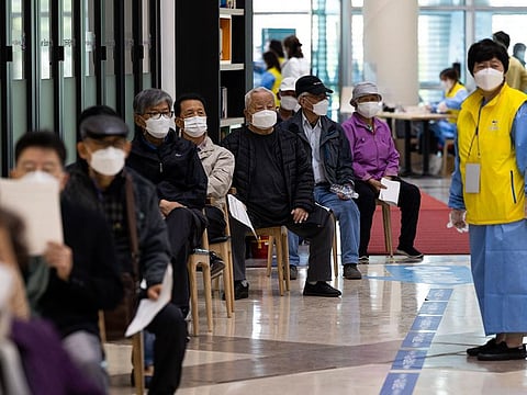 Elderly residents queue in line to receive the first dose of the Pfizer Inc.-BioNTech SE Covid-19 vaccine in Goyang, South Korea, on Thursday, April 1, 2021.