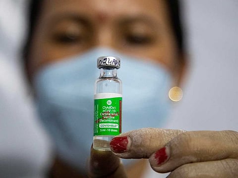 In this Monday, March 1, 2021, file photo, a health worker displays a COVISHIELD vaccine before administering it to an elderly person in Gauhati, India.