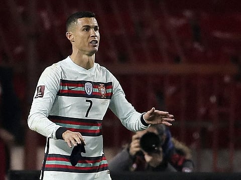 Portugal's forward Cristiano Ronaldo holds his captain armband moments before he threw it to the ground during the FIFA World Cup Qatar 2022 qualification Group A football match.