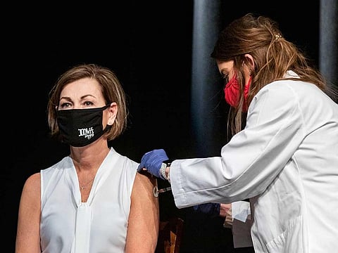 In this March 3, 2021, file photo, Iowa Governor Kim Reynolds gets the Johnson & Johnson COVID-19 vaccine during a news conference at Iowa PBS in Johnston, Iowa.