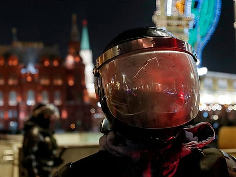 A riot police officer stands guard in front of the Kremlin after Russian opposition leader Alexei Navalny was sentenced to three and a half years in jail, in Moscow, Russia.