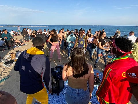 People dance at Barceloneta beach, amid the coronavirus disease (COVID-19) outbreak, in Barcelona, Spain.