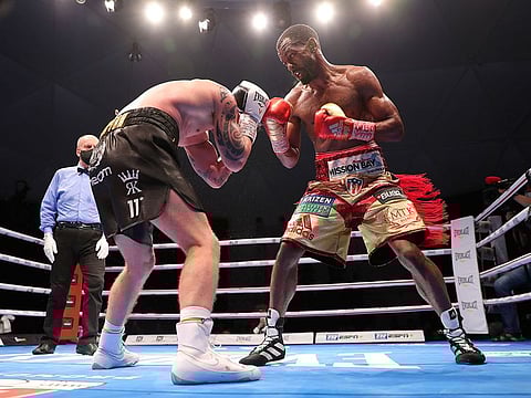 Jamel Herring of the United States, right, lands a blow on Carl Frampton in Dubai