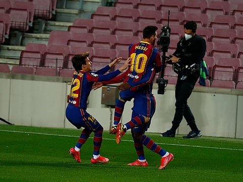 Barcelona’s Ousmane Dembele, right, celebrates after scoring the winner with Lionel Messi and Riqui Puig.