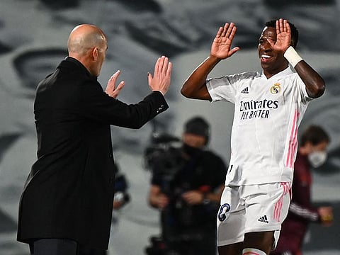 Real Madrid's Brazilian forward Vinicius Junior (right) gets a high five from team boss Zinedine Zidane after scoring during their Uefa Champions League first leg quarter final against Liverpool at the Alfredo di Stefano Stadium in the outskirts of Madrid on Tuesday.
