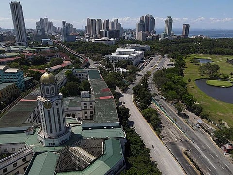 The Manila City Hall stands beside an almost empty road as the government implements a strict lockdown to prevent the spread of the coronavirus on Good Friday, April 2, 2021 in Quezon city, Philippines.