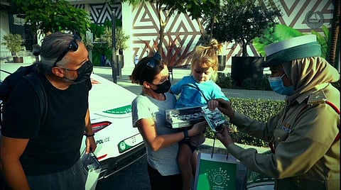 Ryan Noblet with his family and Dubai Police officials.