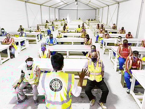 Workers at Expo 2020 Dubai attend a training session as part of the 'Better Together' strategy.