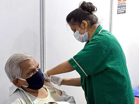 A medic administers the COVID-19 vaccine to the elderly man at Kurla jumbo vaccine centre, in Mumbai on Thursday, April 8, 2021.