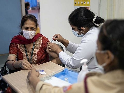 A health care worker administers a COVAXIN COVID-19 vaccine at Dr. Ram Manohar Lohia Hospital in New Delhi on April 9, 2021.