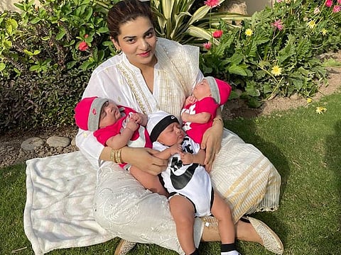 Mum Iqra Nasim with her triplets.