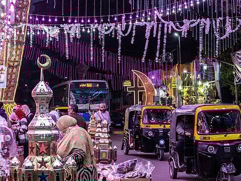 Tuk-tuks (motorised rickshaws) drive past a stall selling Ramadan lanterns along a main street in the in the northern suburb of Shubra (home to a large Christian population) of Egypt's capital Cairo on April 12, 2021, at the start of the Muslim holy fasting month of Ramadan.