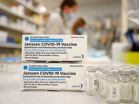 In this March 6, 2021, file photo, boxes stand next to vials of Johnson & Johnson COVID-19 vaccine in the pharmacy of National Jewish Hospital for distribution in east Denver. The drug maker decided Tuesday, April 13, to delay deliveries to Europe after the American regulator recommended a pause in the vaccine's use in the United States while very rare blood clot cases are examined.