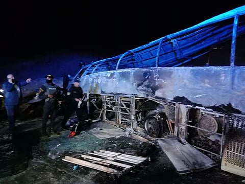 Wreckage of the bus charred due to the collision.