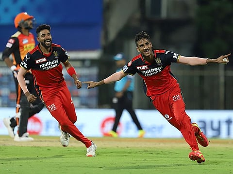 Shahbaz Ahmed of the Royal Challengers Bangalore takes flight after claiming a wicket against Sunrisers Hyderabad in the IPL match in Chennai on April 14, 2021.