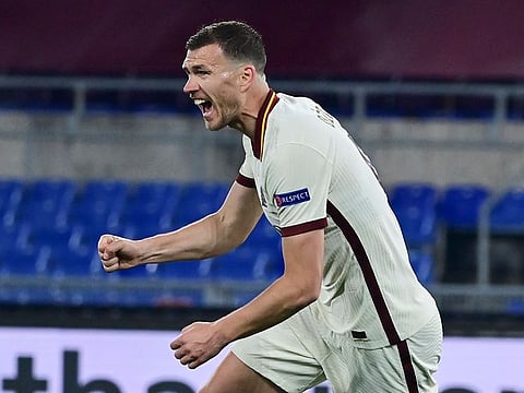 Roma's Edin Dzeko celebrates after scoring.