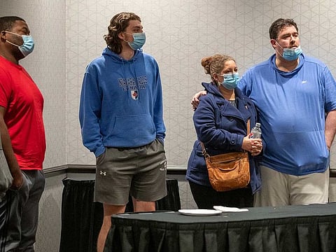 Family members await information about their loved ones who work at the FedEx facility in Indianapolis where a mass casualty shooting occurred late Thursday, early Friday, April 16, 2021.