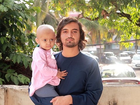 Two-and-a-half-year-old Afghan girl Kulsum with her father Mohammed after the bone marrow transplant in Calicut.