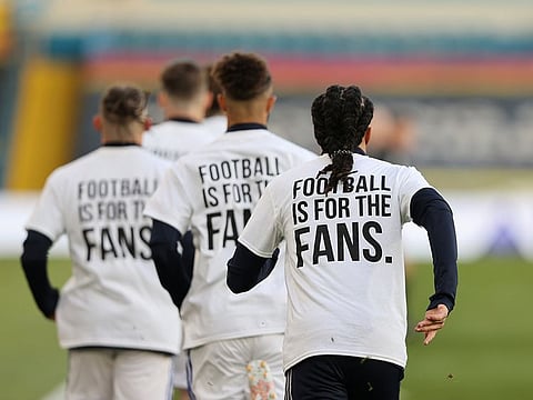 Leeds United players during the warm up before the match wearing UEFA Champions League t-shirts with messages against the Super League.