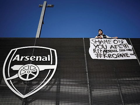 An Arsenal fan stands with his anti-European Super League banner outside the Emirates Stadium on April 19, 2021.