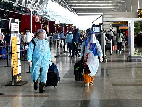 Passengers in full PPE kit at the Indira Gandhi International Airport in New Delhi.