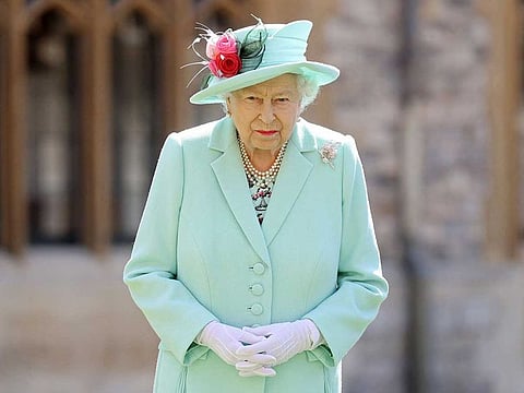 In this file photo taken on July 17, 2020 Britain's Queen Elizabeth II poses after confering the honour of a knighthood upon 100-year-old veteran Captain Tom Moore