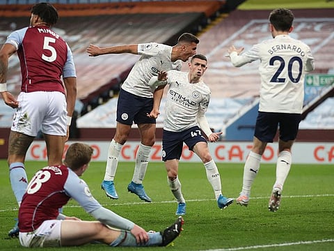Manchester City's Phil Foden (2R) celebrates scoring.