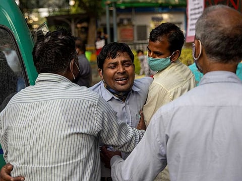 Family members mourn after a COVID patient is declared dead outside the coronavirus disease (COVID-19) casualty ward at a hospital in New Delhi, India (late April 2021)