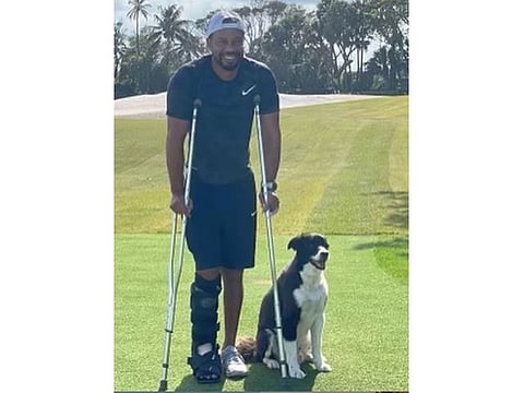 Tiger Woods on his golf course with pet dog Bugs