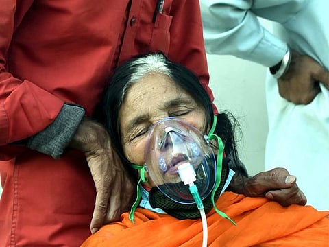 A COVID-19 patient receives free oxygen, provided by a Sikh organization at Indirapuram Gurudwara.