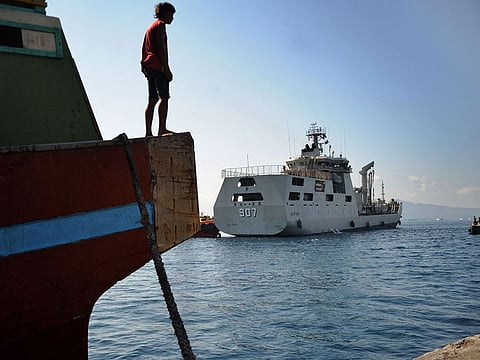 The Indonesian Navy patrol boat KRI Bontang (907) (C) arrives at a naval base in Banyuwangi, East Java province on April 26, 2021, after an Indonesian submarine that disappeared last week had been found in pieces on the seafloor with all 53 crew aboard killed.