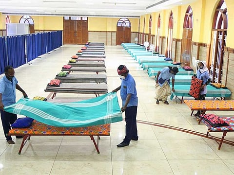Healthcare workers set beds at Covid First Line Treatment Centre (CFLTC) for COVID-19 patients amid the rise in cases, in Kochi on Friday, April 23, 2021.