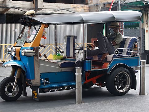 A tuk tuk driver wearing a face mask to help curb the spread of the coronavirus waits for customers in Khao San road, a popular hangout for Thais and tourists in Bangkok, Thailand, Monday, April 26, 2021.