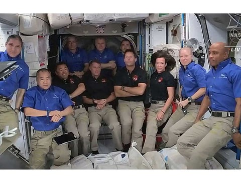 This screen grab taken from the NASA live feed shows crew members of the International Space Station welcoming crew members of the SpaceX's Crew Dragon spacecraft, on April 24.