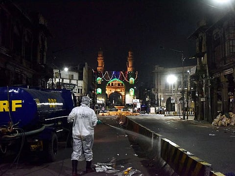 A worker sanitises the road as a precautionary measure to contain the rise in Coronavirus cases, in Hyderabad