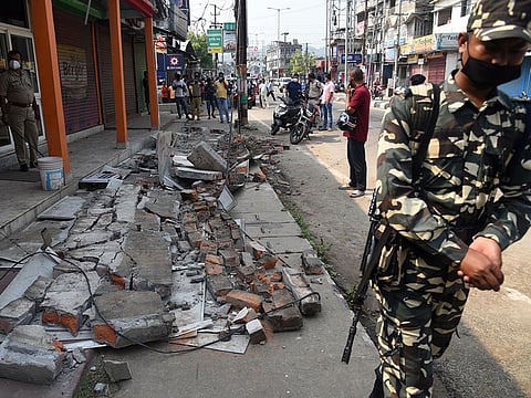 A CRPF personnel stand guards near an earthquake-damaged building at Bhetapara in Guwahati, Wednesday, April 28, 2021.