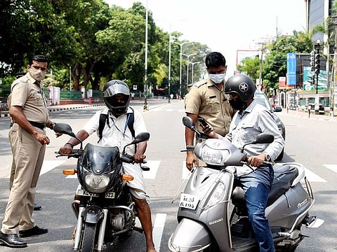 Police personnel stop commuters during the weekend lockdown at Palayam in Thiruvananthapuram on Saturday, April 24, 2021.